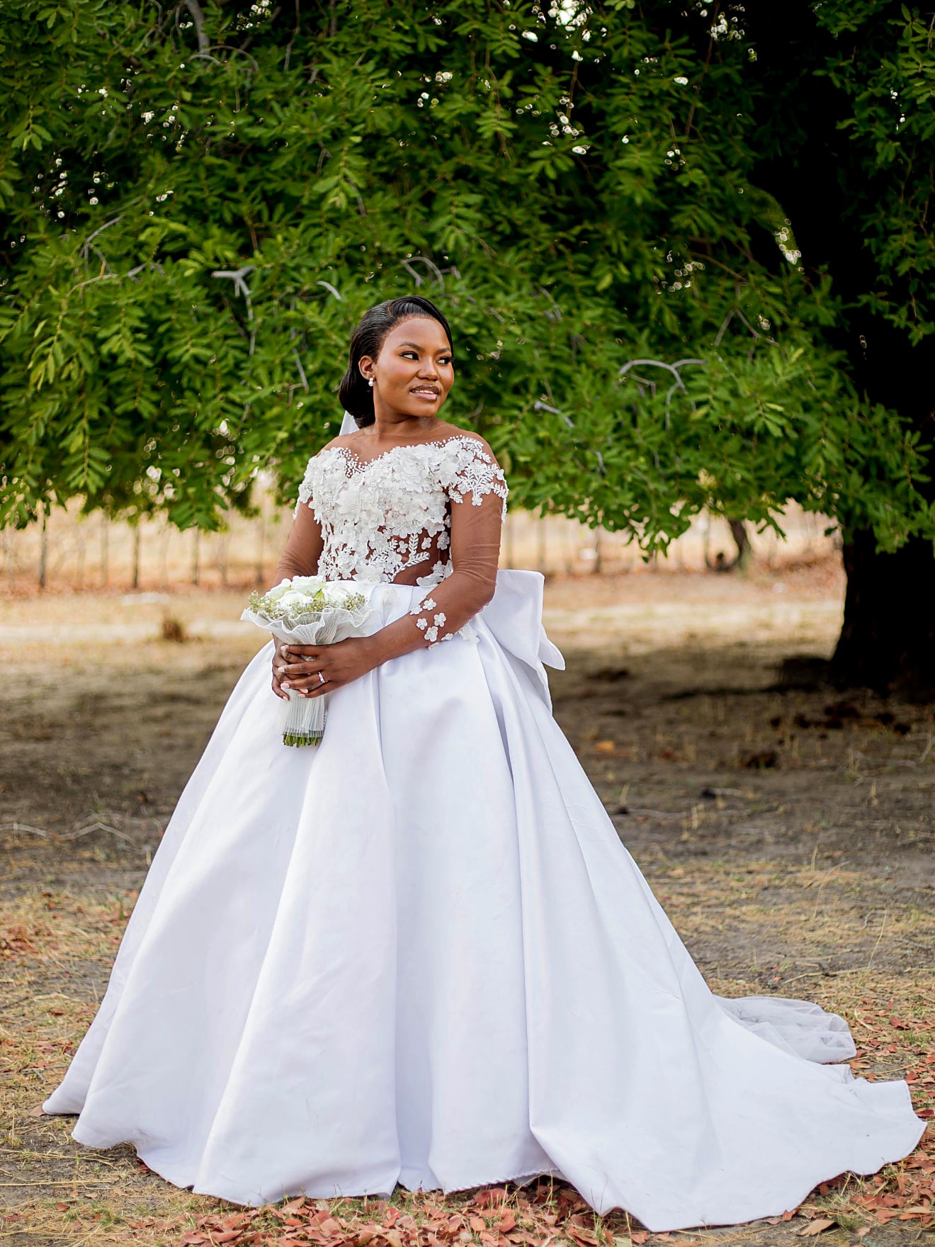 Side view of the mikado bridal ball gown showing the oversized back bow and sweeping train