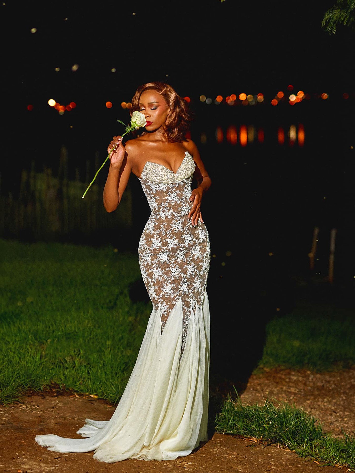 Bride in a pearl-bust corded lace mermaid wedding gown with a chiffon fishtail