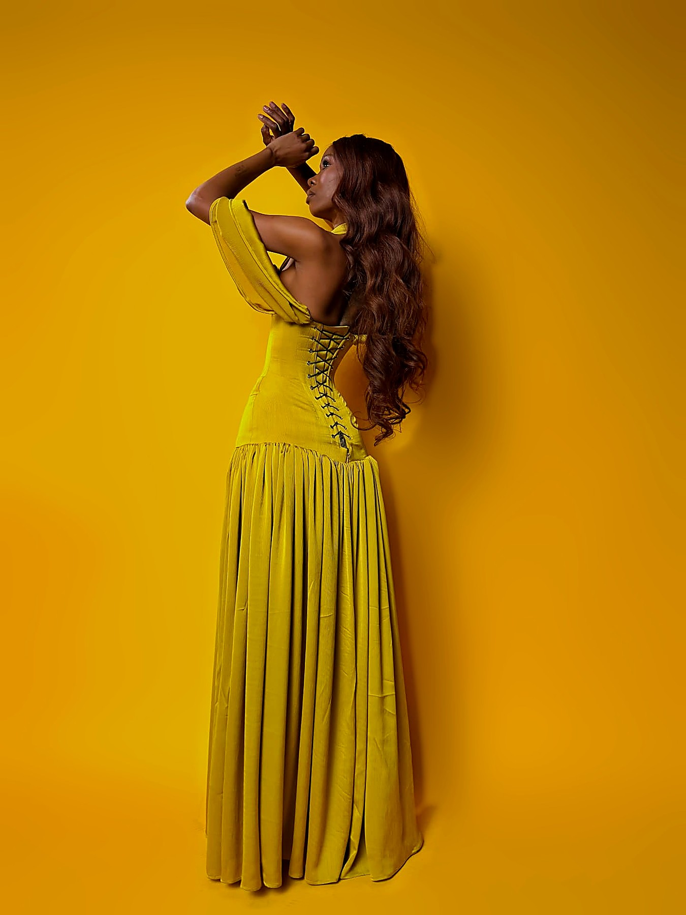 Laced corset back of the chartreuse silk gown