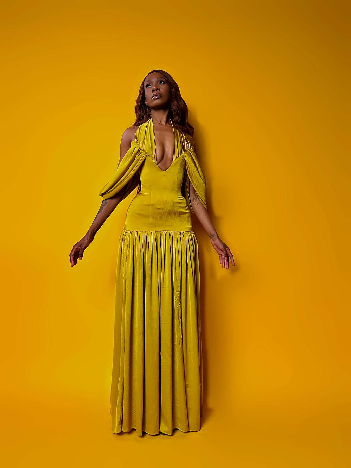 Chartreuse plunge halter gown with draped off-shoulder sleeves