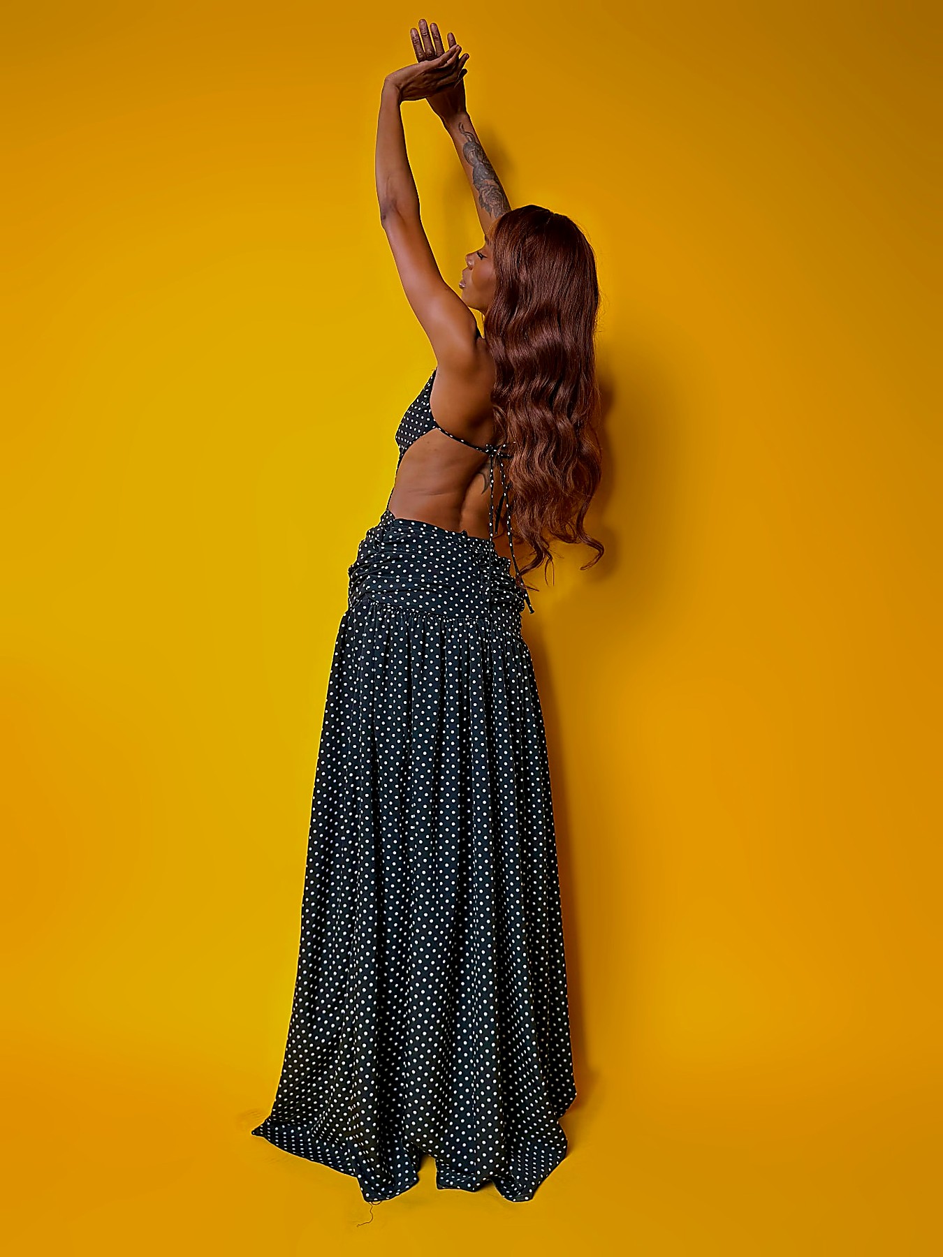 Side profile of the polka dot maxi showing the full gathered chiffon skirt
