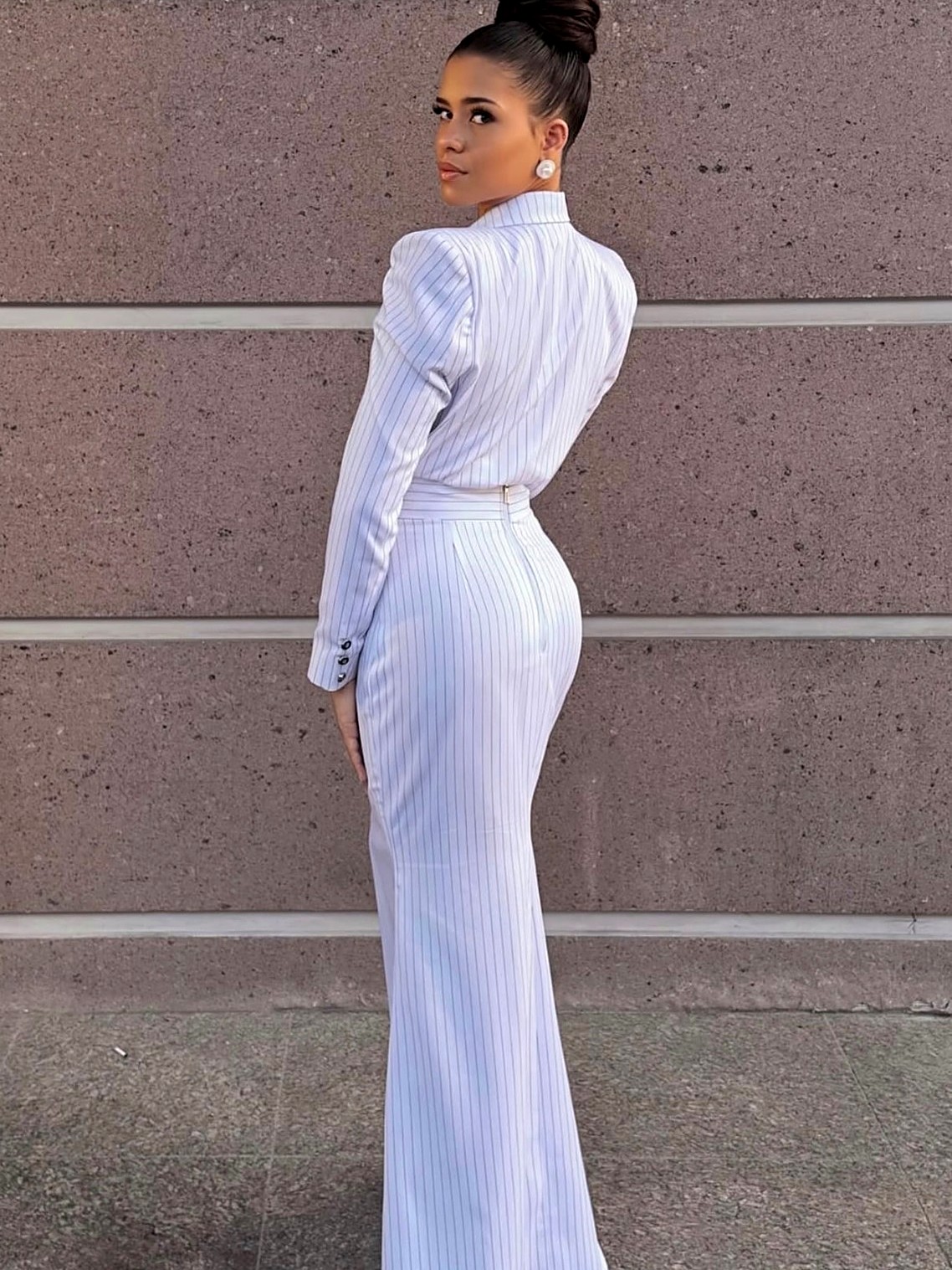 Back view of the ivory pinstripe column skirt suit showing the sculpted shoulders and fitted seams