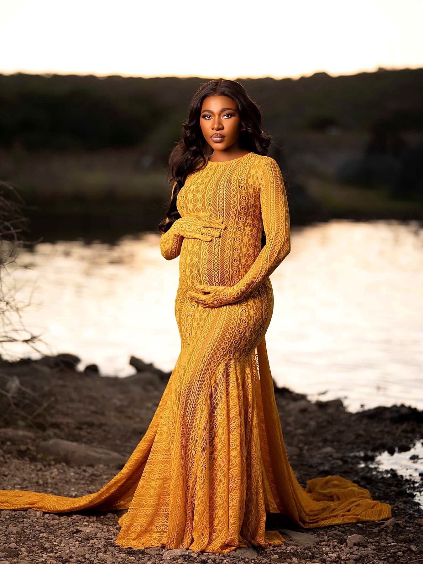 Saffron patterned lace maternity gown with long sleeves and a fishtail hem at sunset